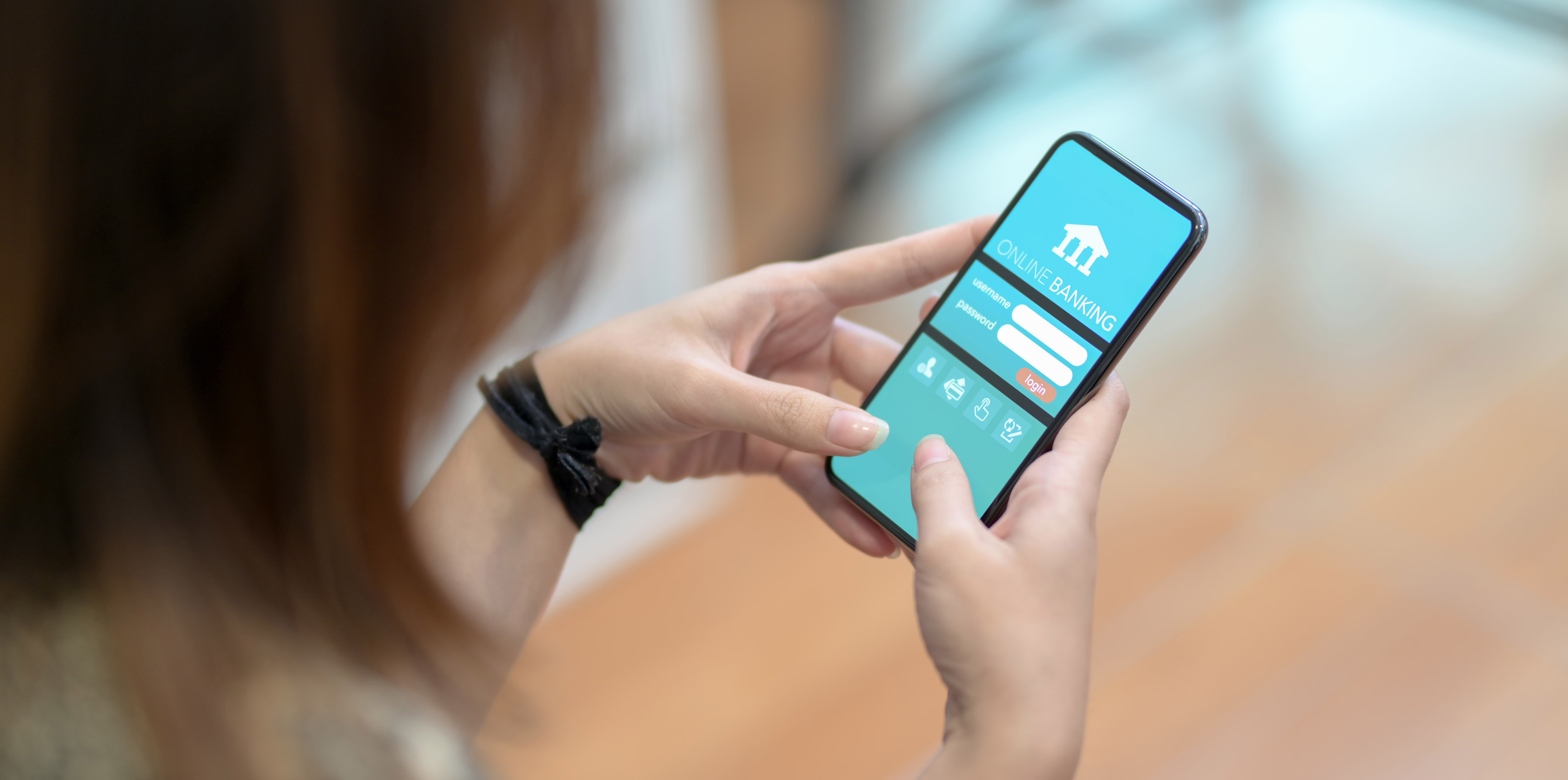 Woman doing online banking on smartphone short codes program