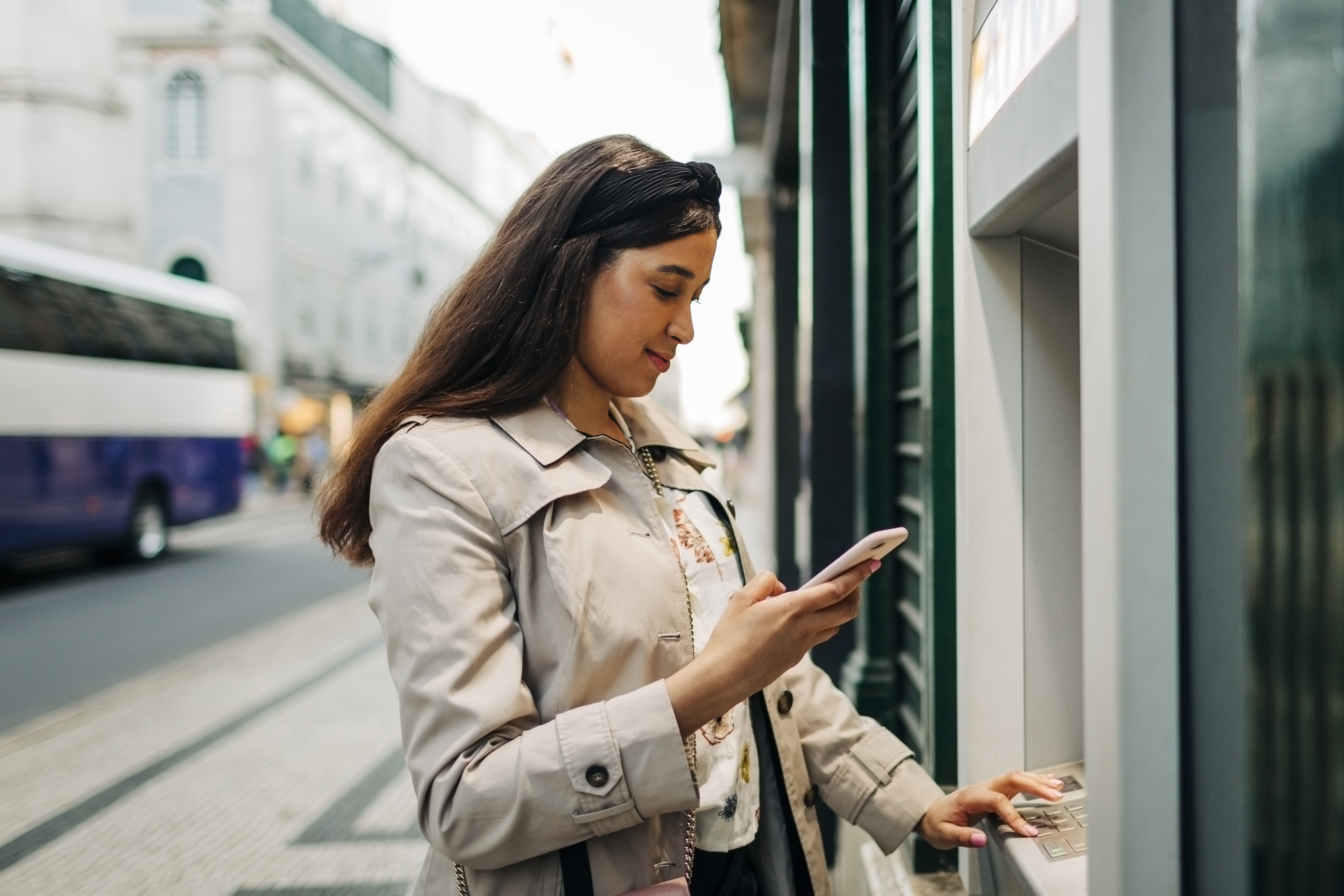 Woman uses her mobile phone to double check bank information