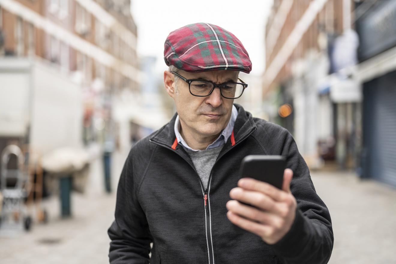 man-looking-concerned-after-receiving-fraud-alert-on-smartphone-short-codes-program