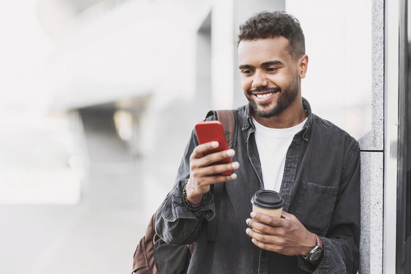 man holding phone and smiling