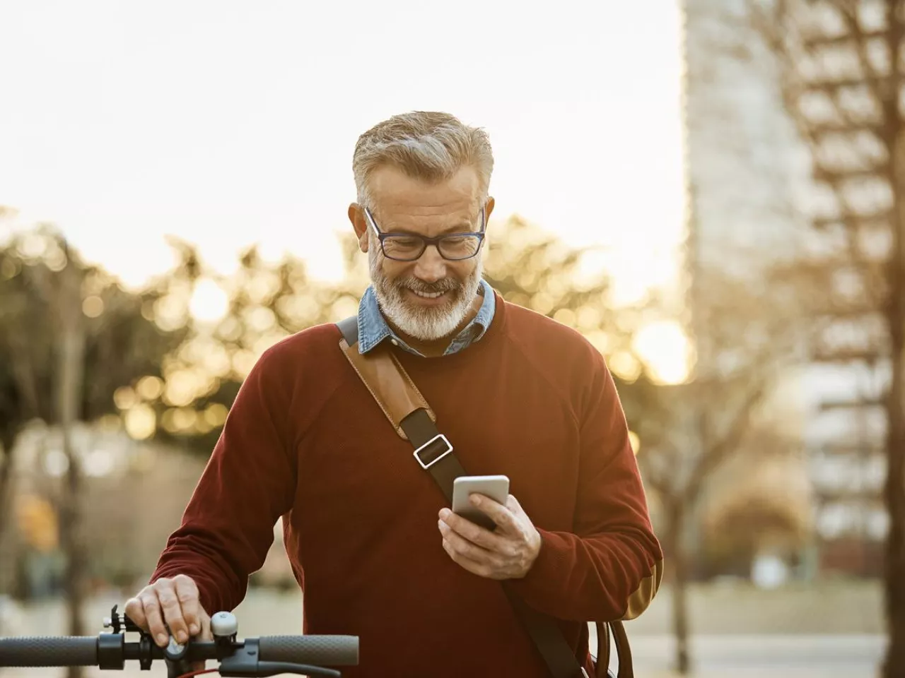 Man with a bike checking his smartphone
