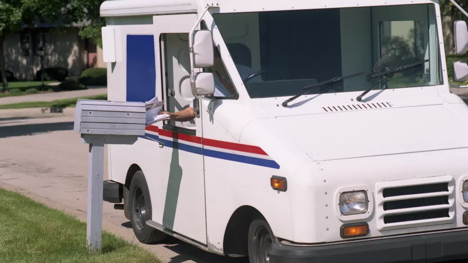 USPS worker delivering mail after customer received an 'out for delivery' alert