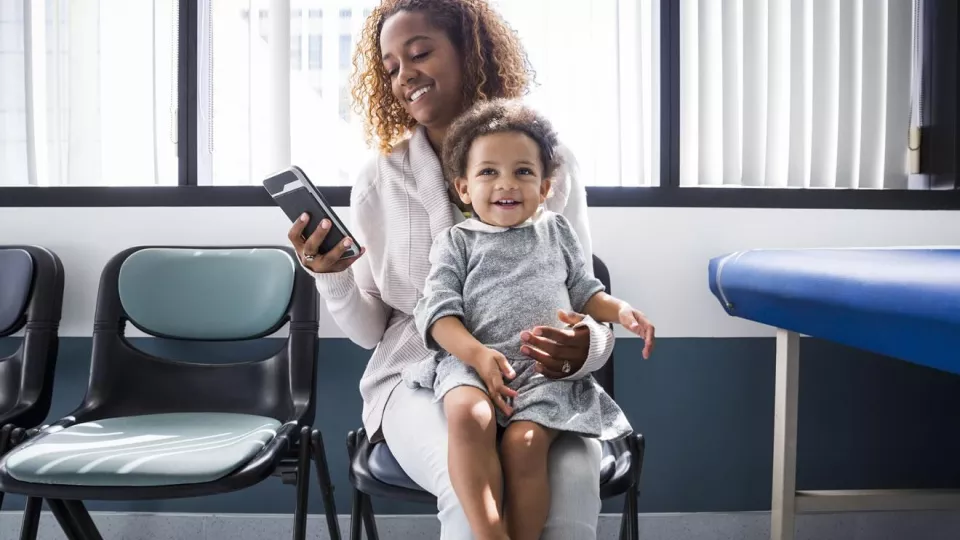 Woman with her child checking her phone